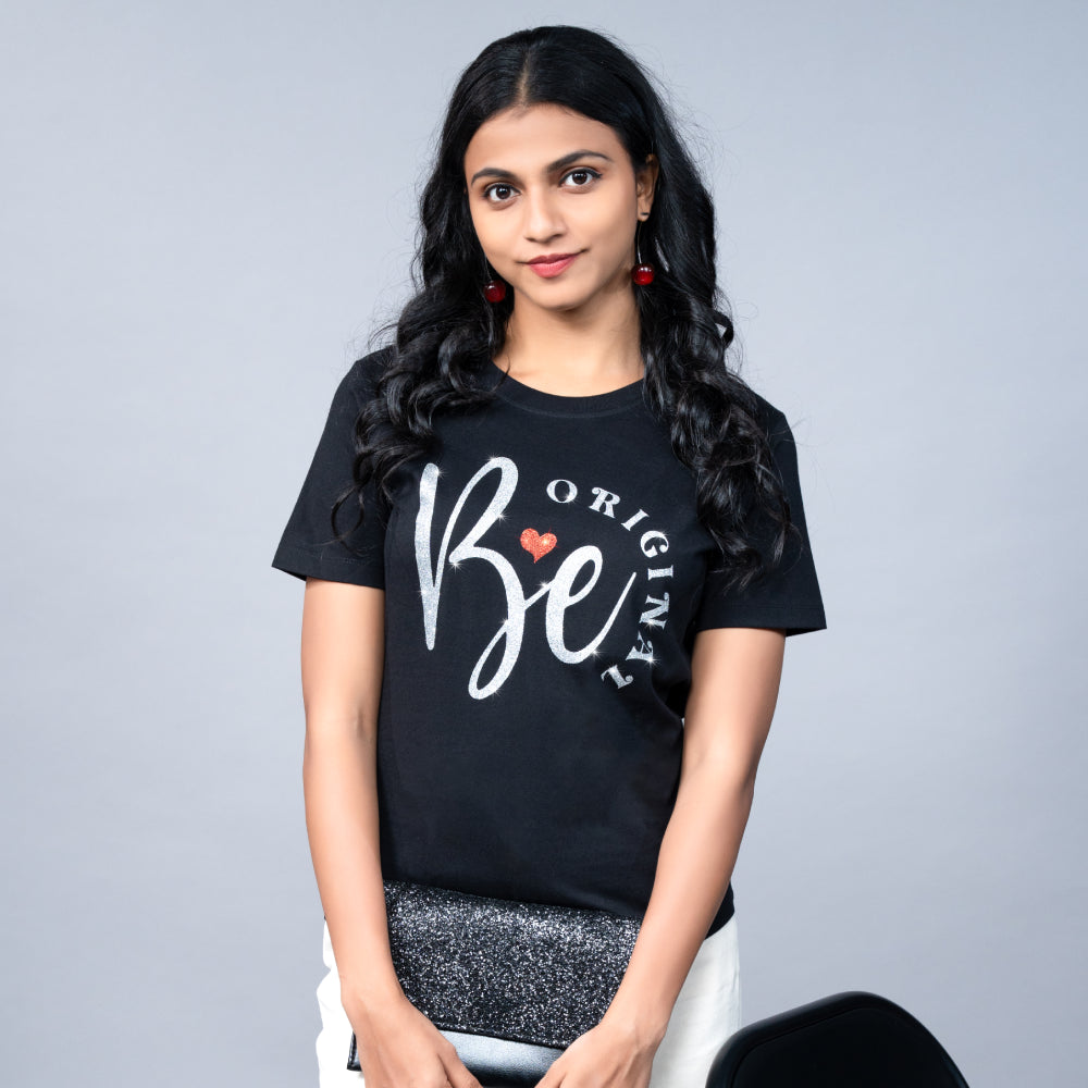 Side view of black Be Original tee on model, relaxed fit with shimmering text