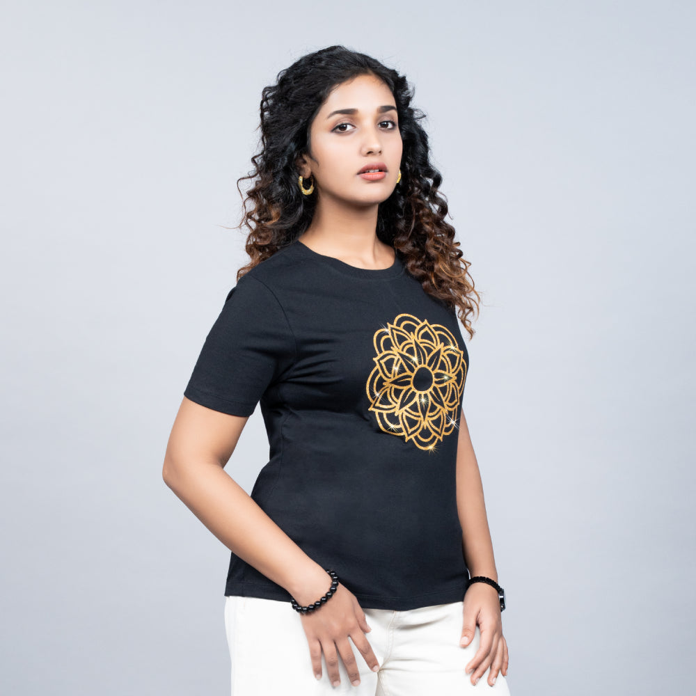 Woman wearing Black Mandala tee paired with palazzos in serene luxe style