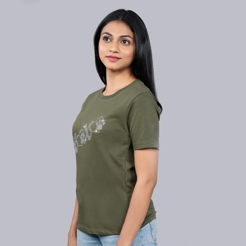 Woman wearing XoXo tee styled with high-waist trousers—chic and confident vibes