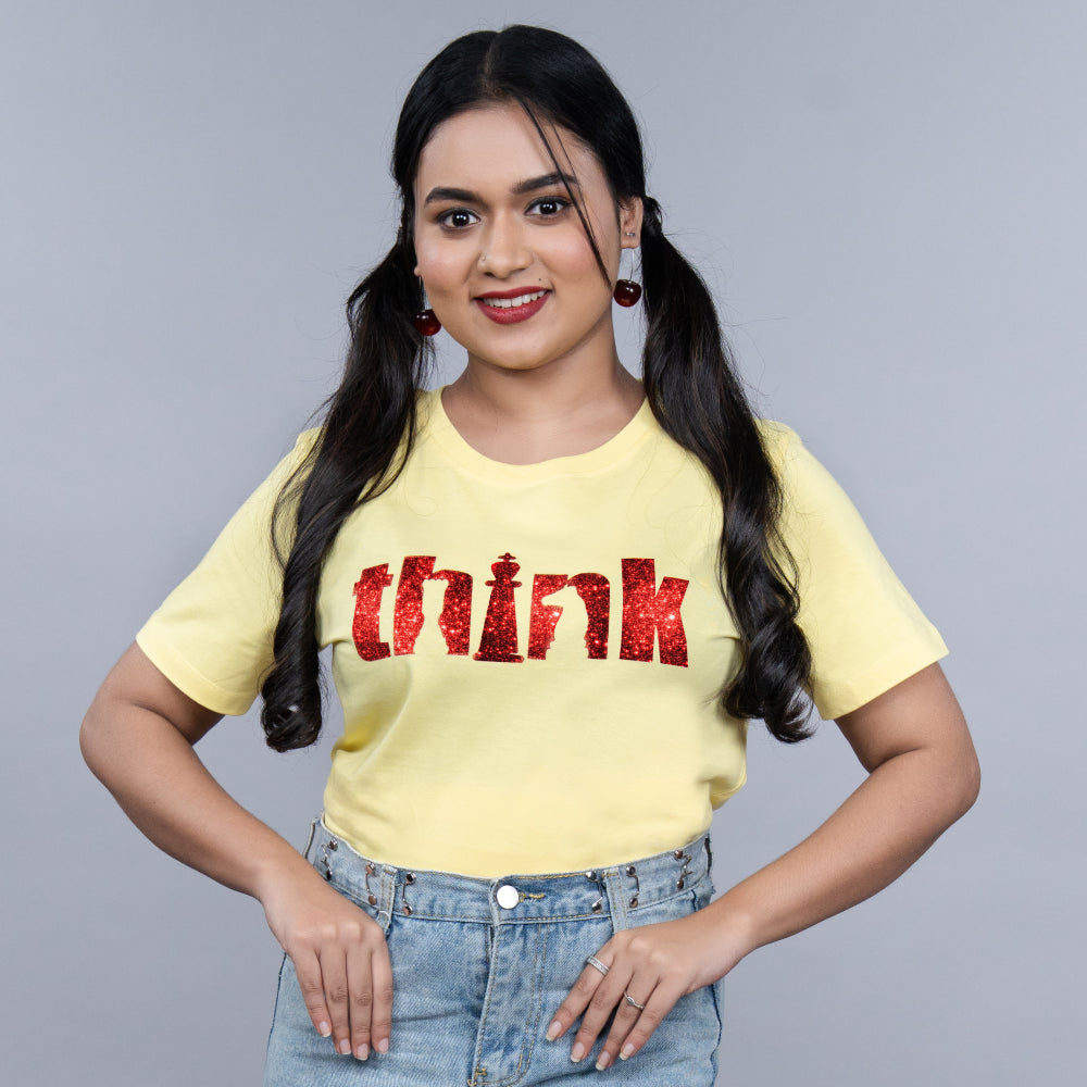 Yellow “Think” women’s cotton tee with glitter typography – side angle