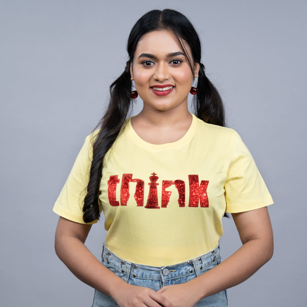 Stylish women’s yellow “Think” glitter tee with crown detail – full outfit look