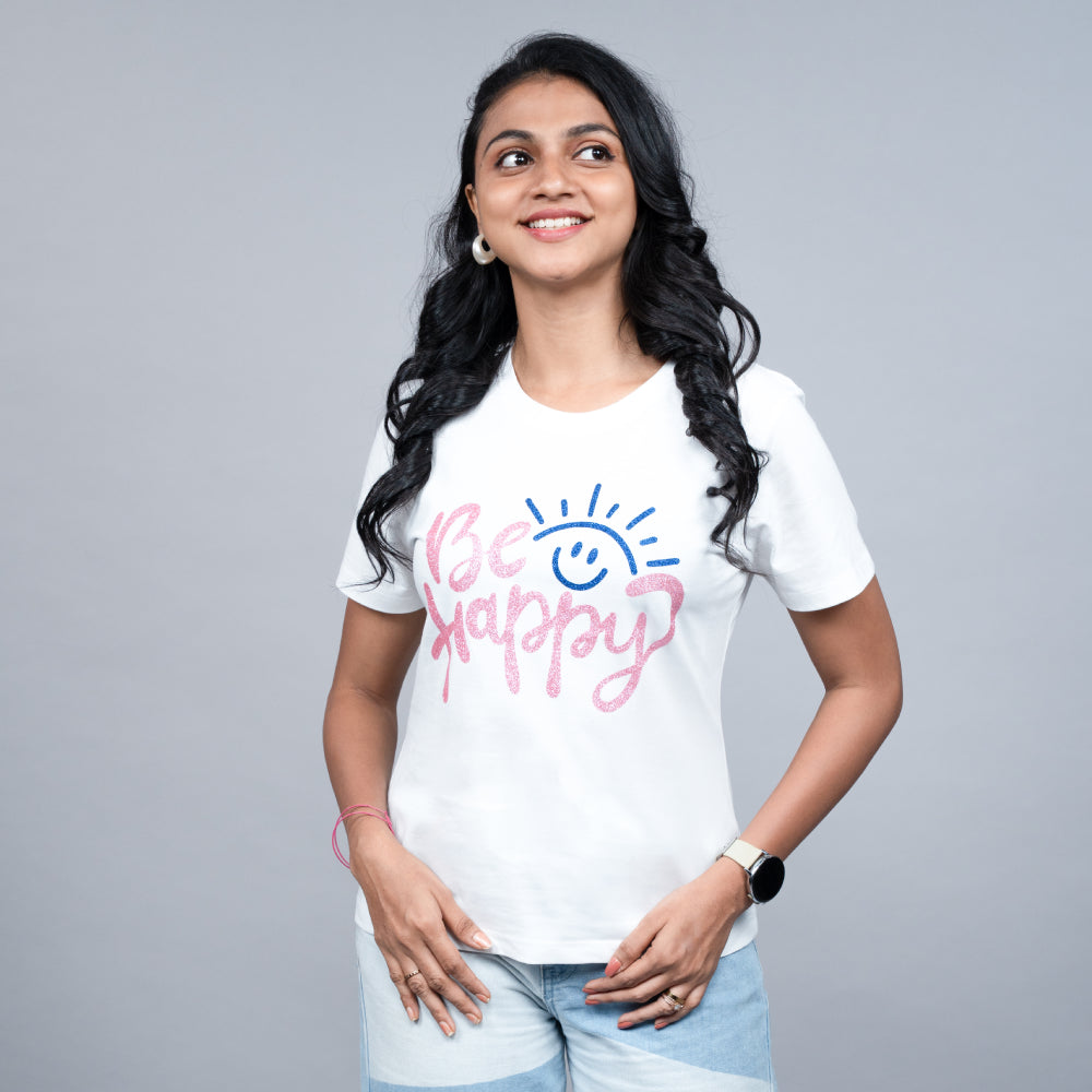 Angled side view of white Be Happy tee on model, showing relaxed fit and sparkle