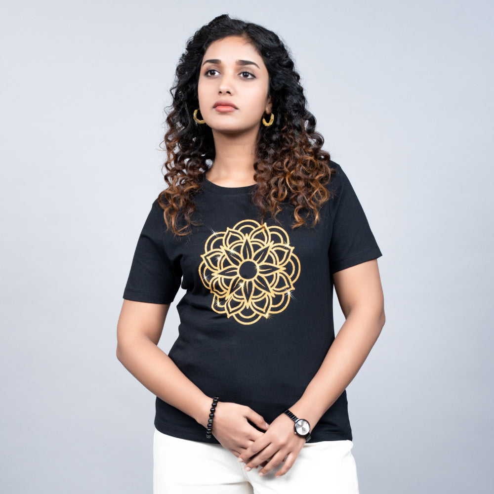 Side view of black Mandala tee on model, showcasing relaxed fit and shimmering motif