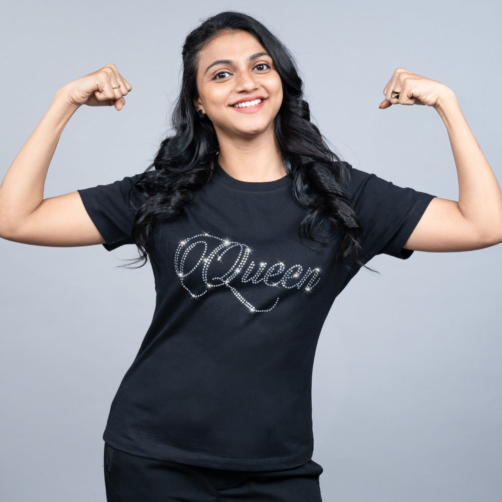 Close-up of black “Queen” tee highlighting glitter-studded “Queen” text on soft cotton fabric