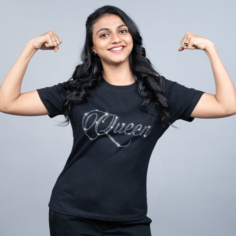 Close-up of black “Queen” tee highlighting glitter-studded “Queen” text on soft cotton fabric
