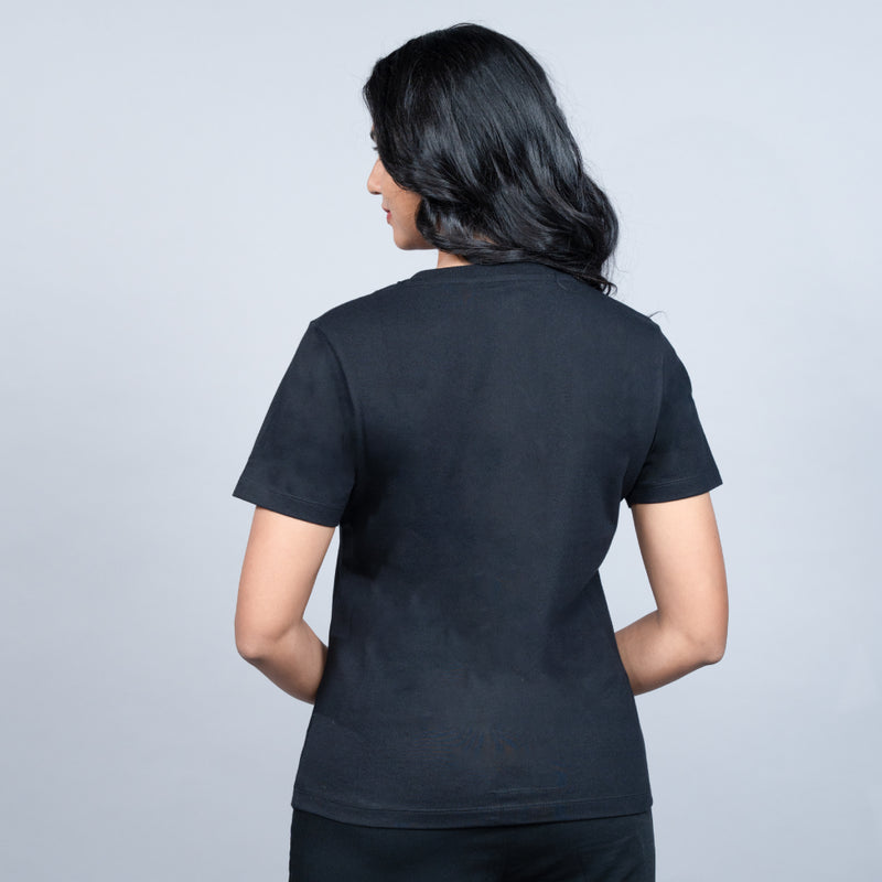 Side-angle of black “Queen” tee showcasing relaxed fit and shimmering text detail