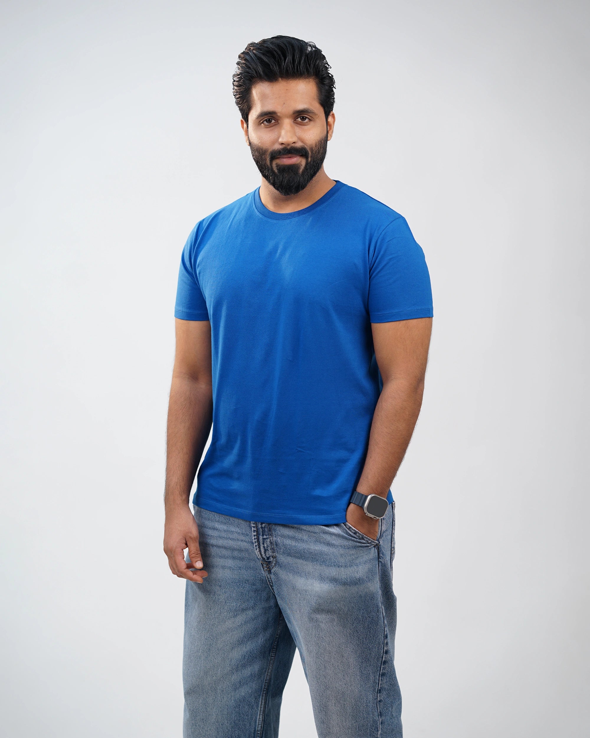 Man wearing royal-blue crewneck tee with casual pants—relaxed yet refined everyday style