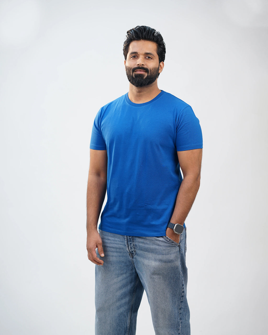Man walking in royal-blue tee—effortless comfort meets dynamic daily ease