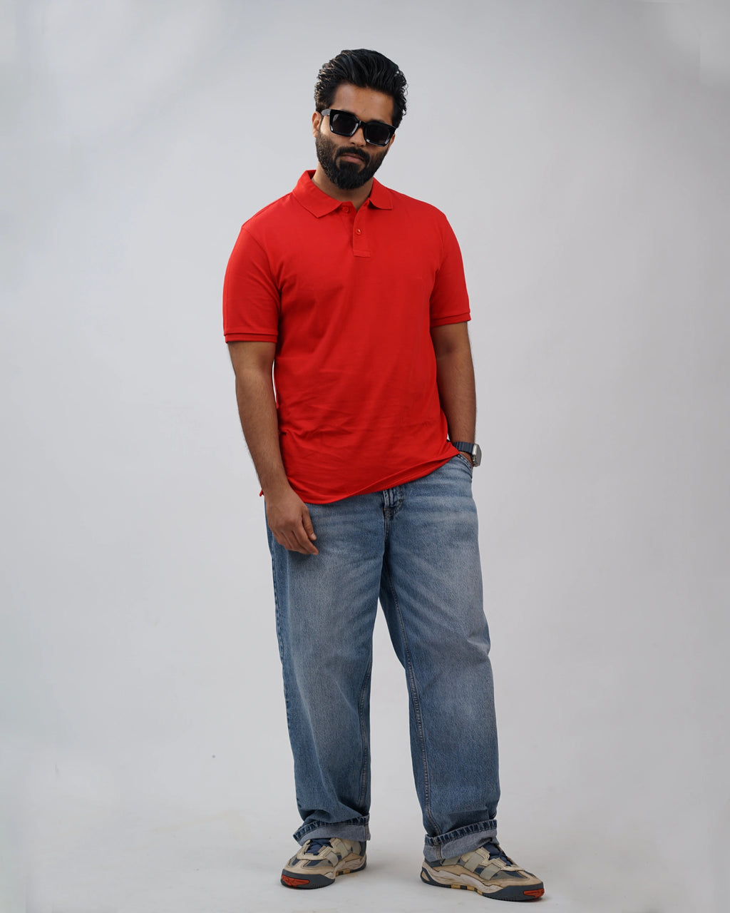Close-up of minimalist collar and stitching on red polo, reflecting tailored craftsmanship