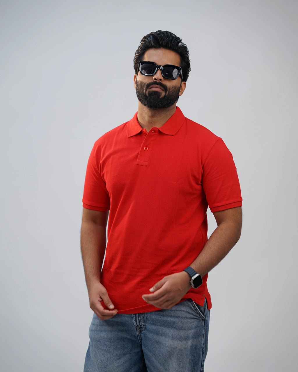 Man in bold red polo tee paired with chinos—modern polish meets classic style