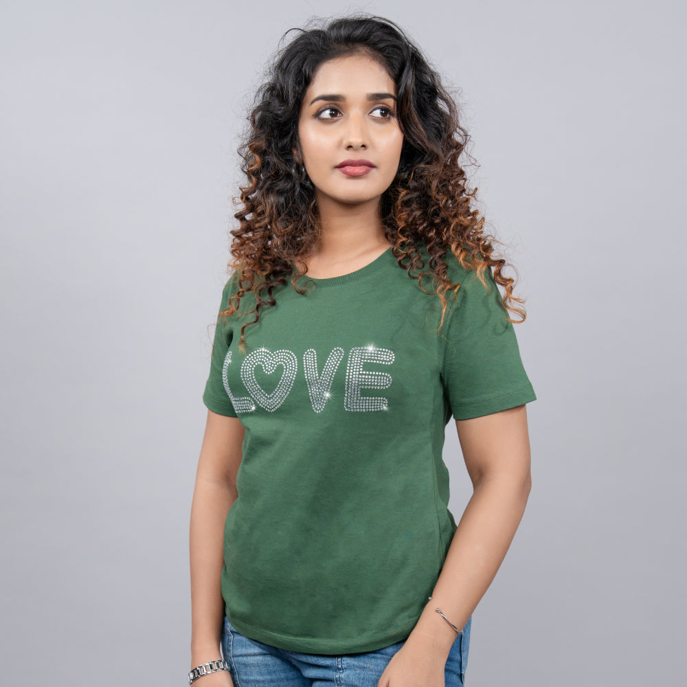Side angle of bottle-green “Love” tee showing soft fit and heart detail