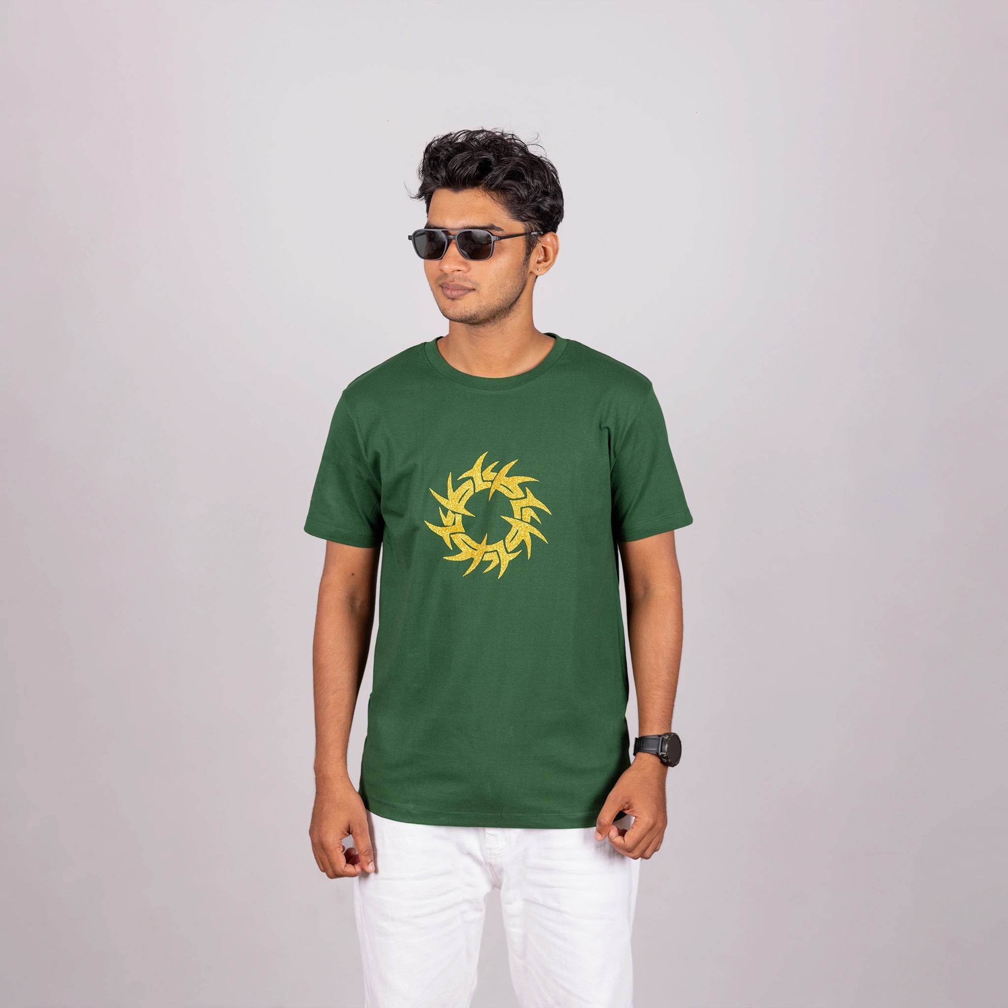Man walking in bottle green tee with urban ease—glitter graphic meets dynamic movement