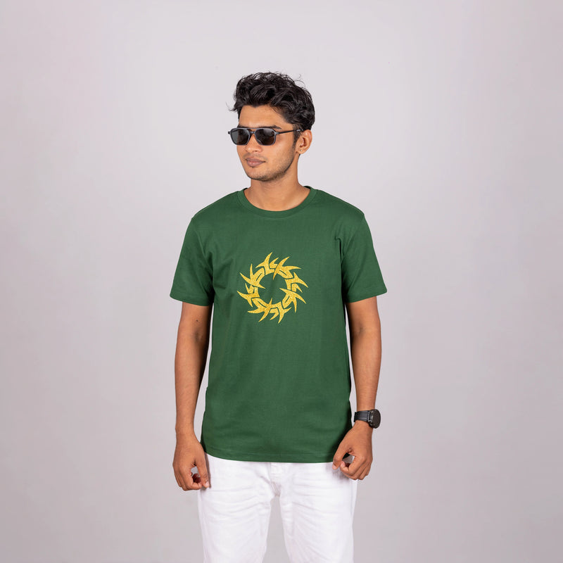 Man walking in bottle green tee with urban ease—glitter graphic meets dynamic movement