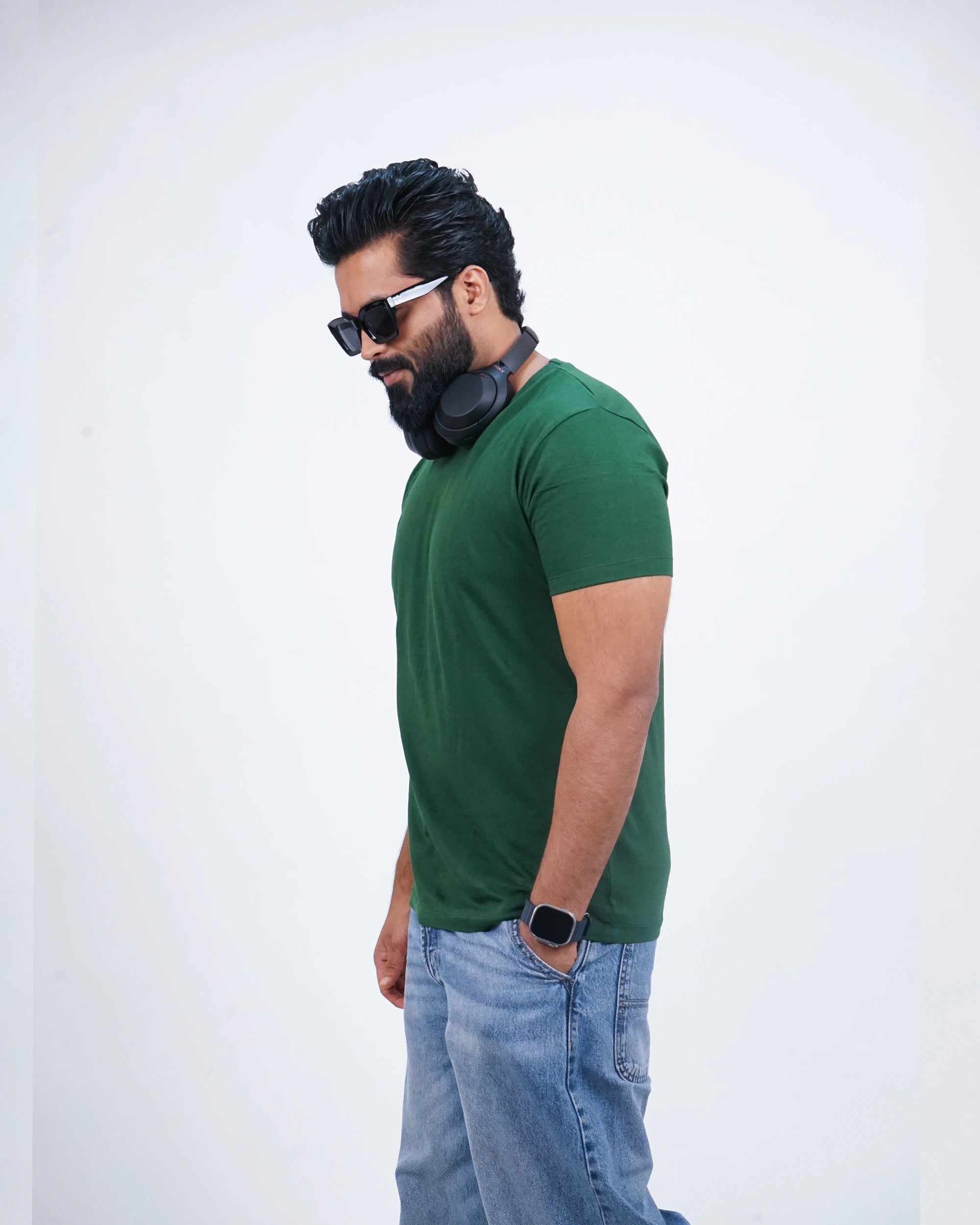 Side profile of a bottle green tee for men showing relaxed fit and cool tone