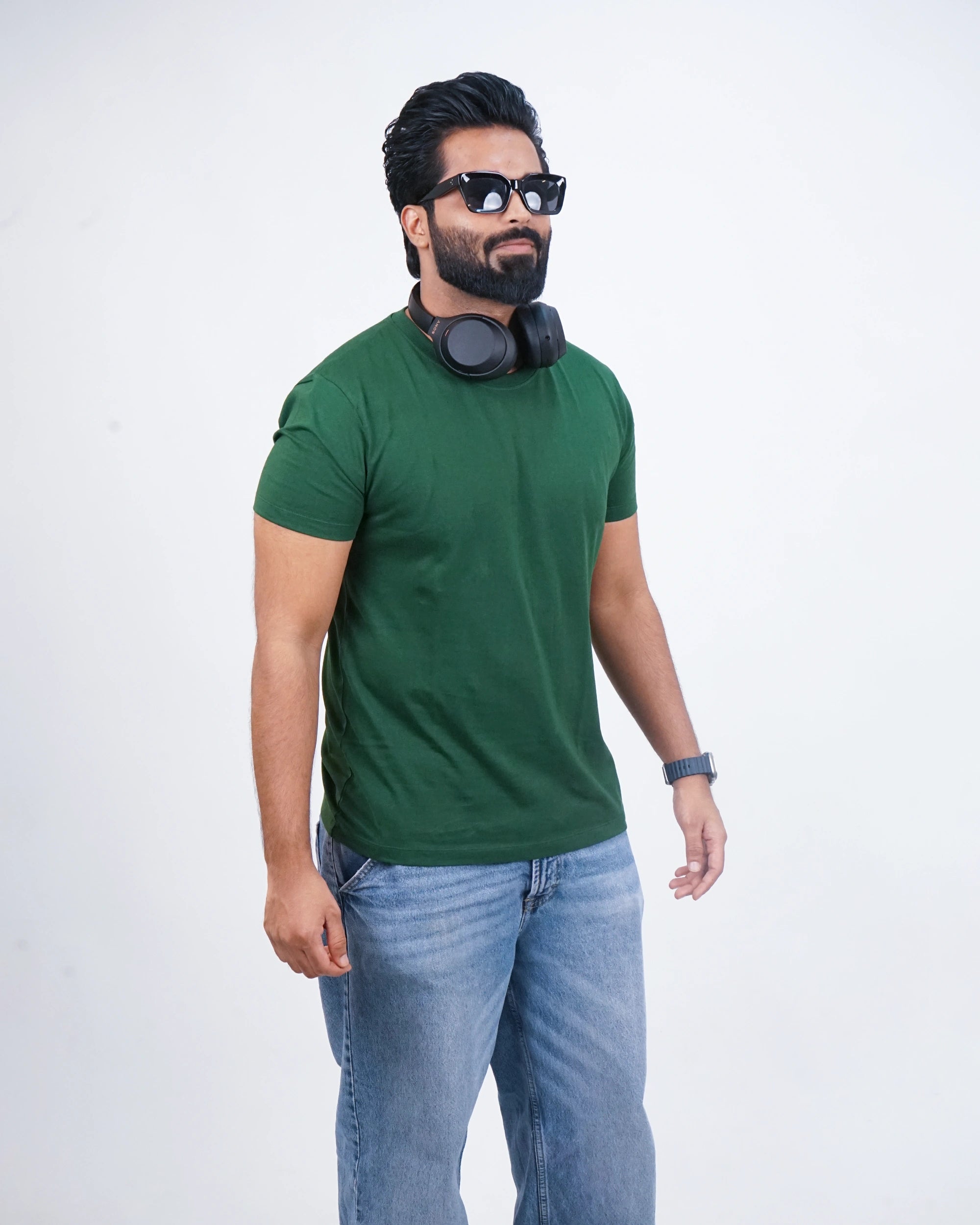 Man walking in bottle green round neck tee—chill, sharp style meets everyday motion