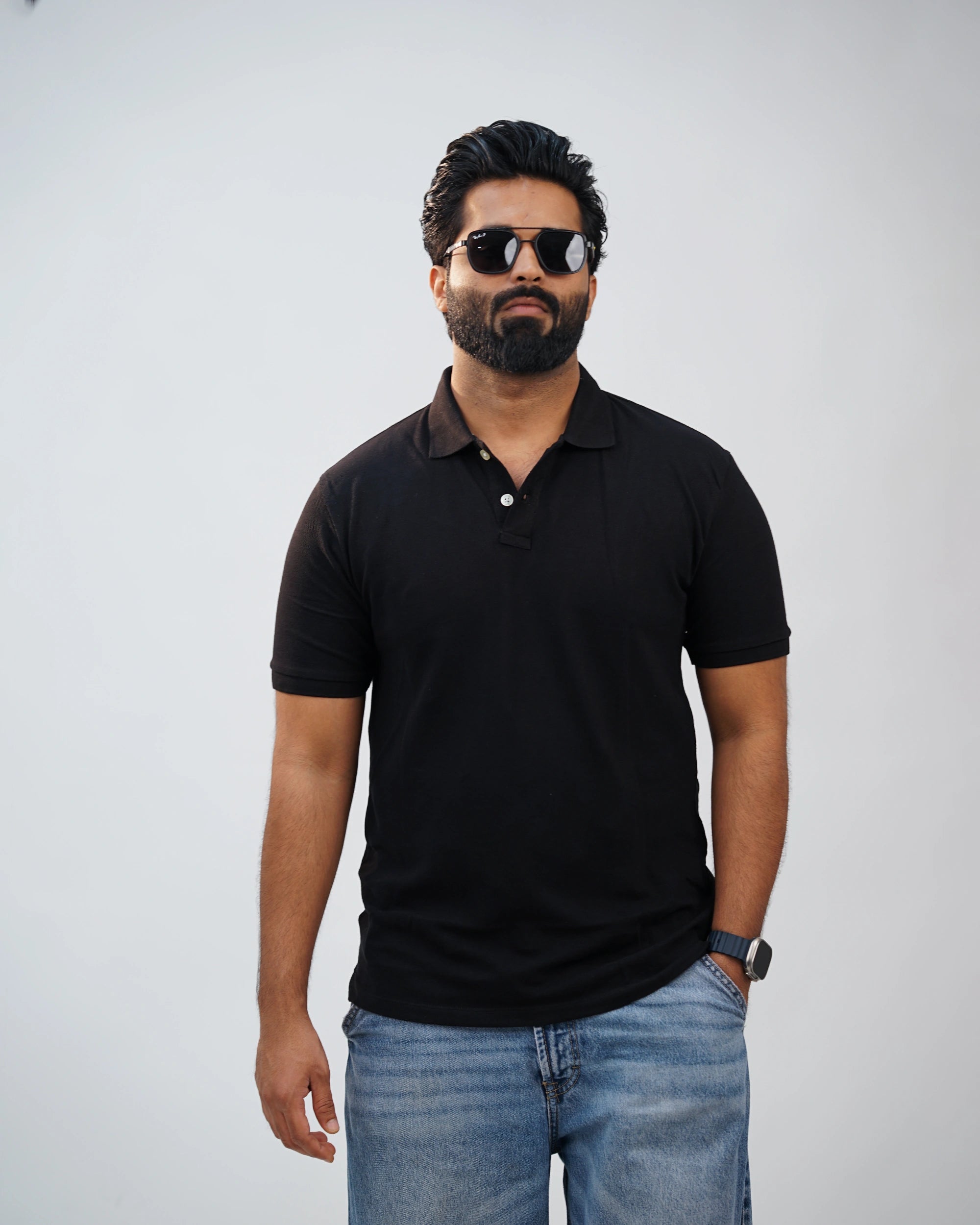 Close-up of minimalist collar and premium stitching on black polo tee—tailored detailing