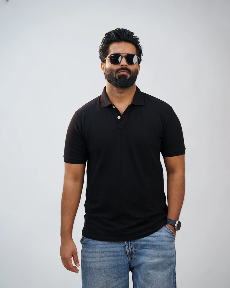 Close-up of minimalist collar and premium stitching on black polo tee—tailored detailing