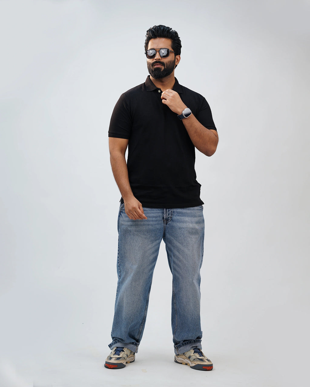 Man dressed casually in black polo—effortless comfort with everyday polish