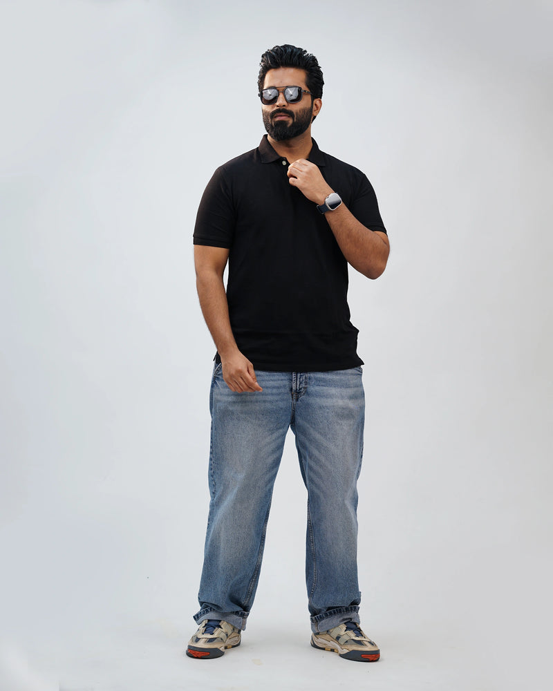 Man dressed casually in black polo—effortless comfort with everyday polish