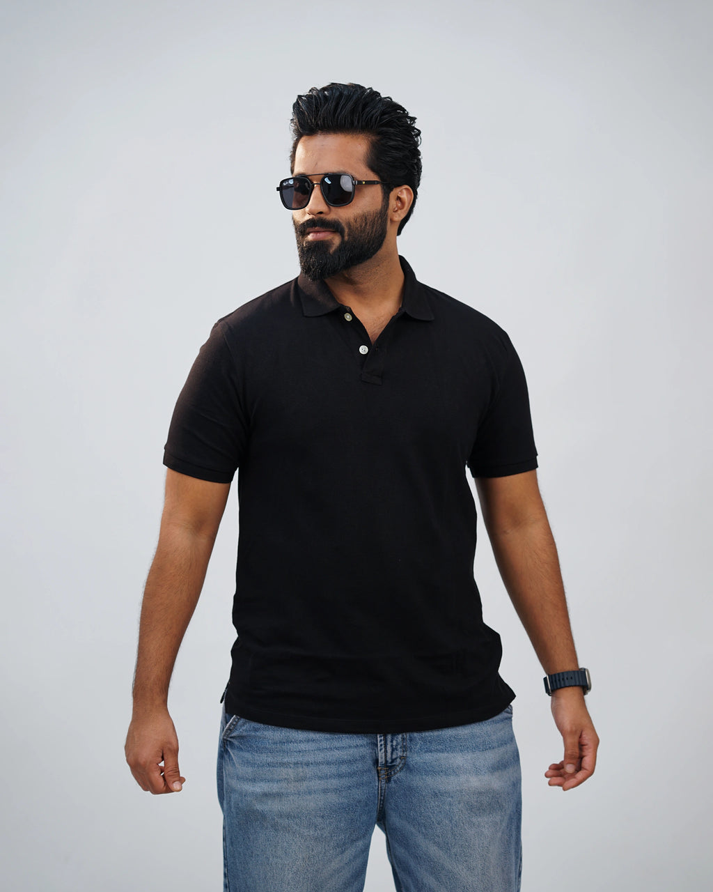 Man wearing classic black polo tee paired with chinos—simple elegance meets modern flair