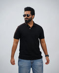 Man wearing classic black polo tee paired with chinos—simple elegance meets modern flair