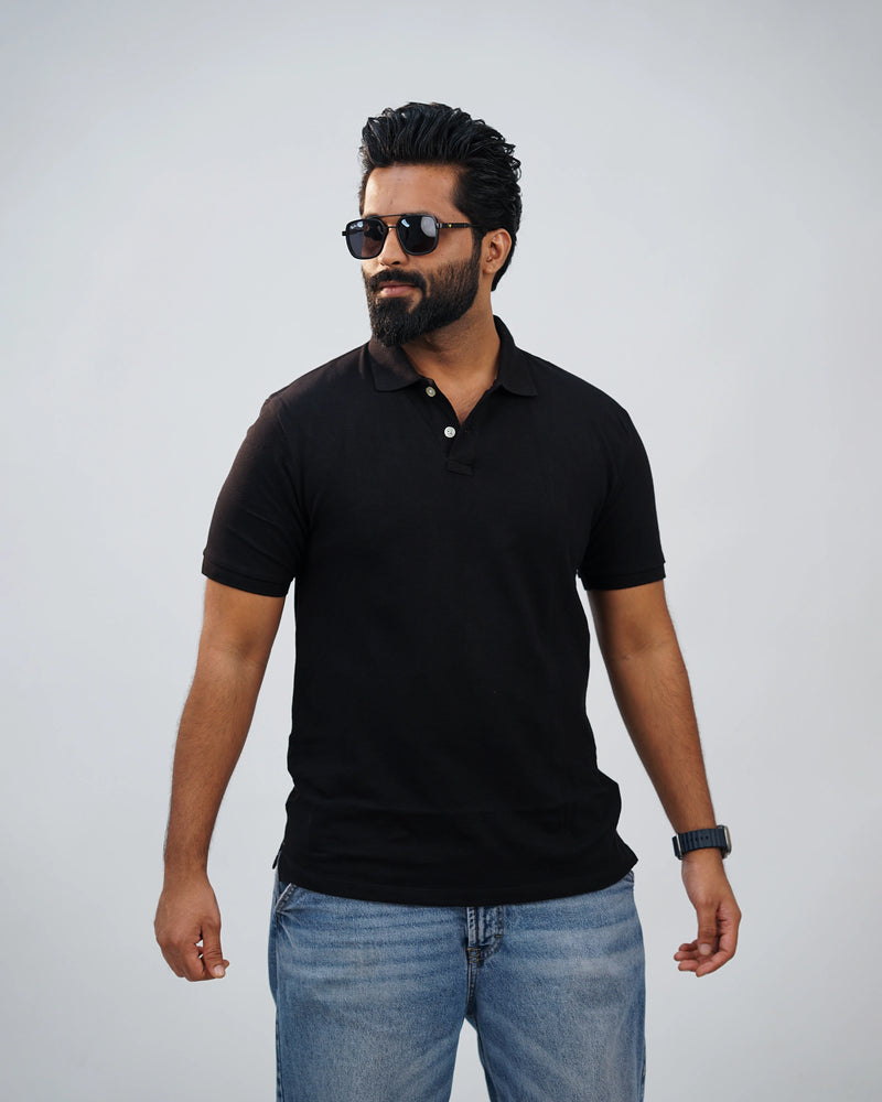 Man wearing classic black polo tee paired with chinos—simple elegance meets modern flair