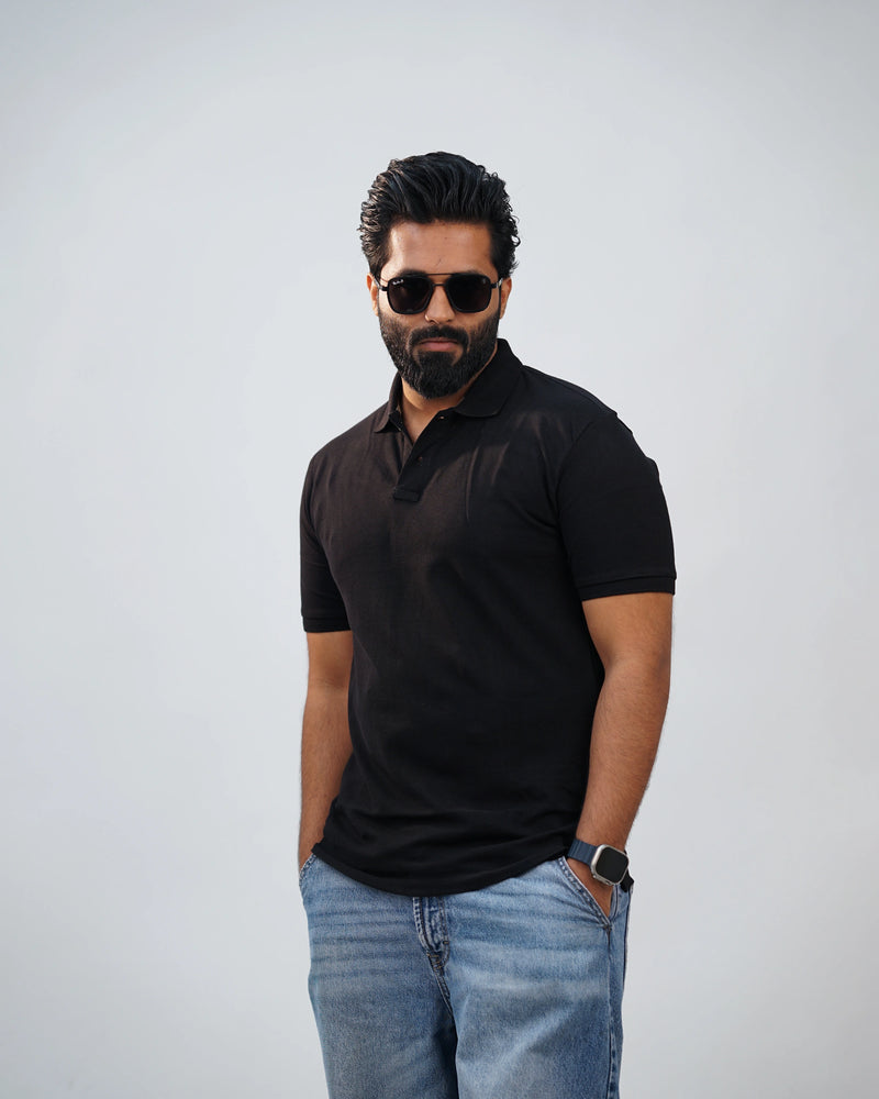 Side-angle of black polo highlighting structured fit and smooth fabric drape