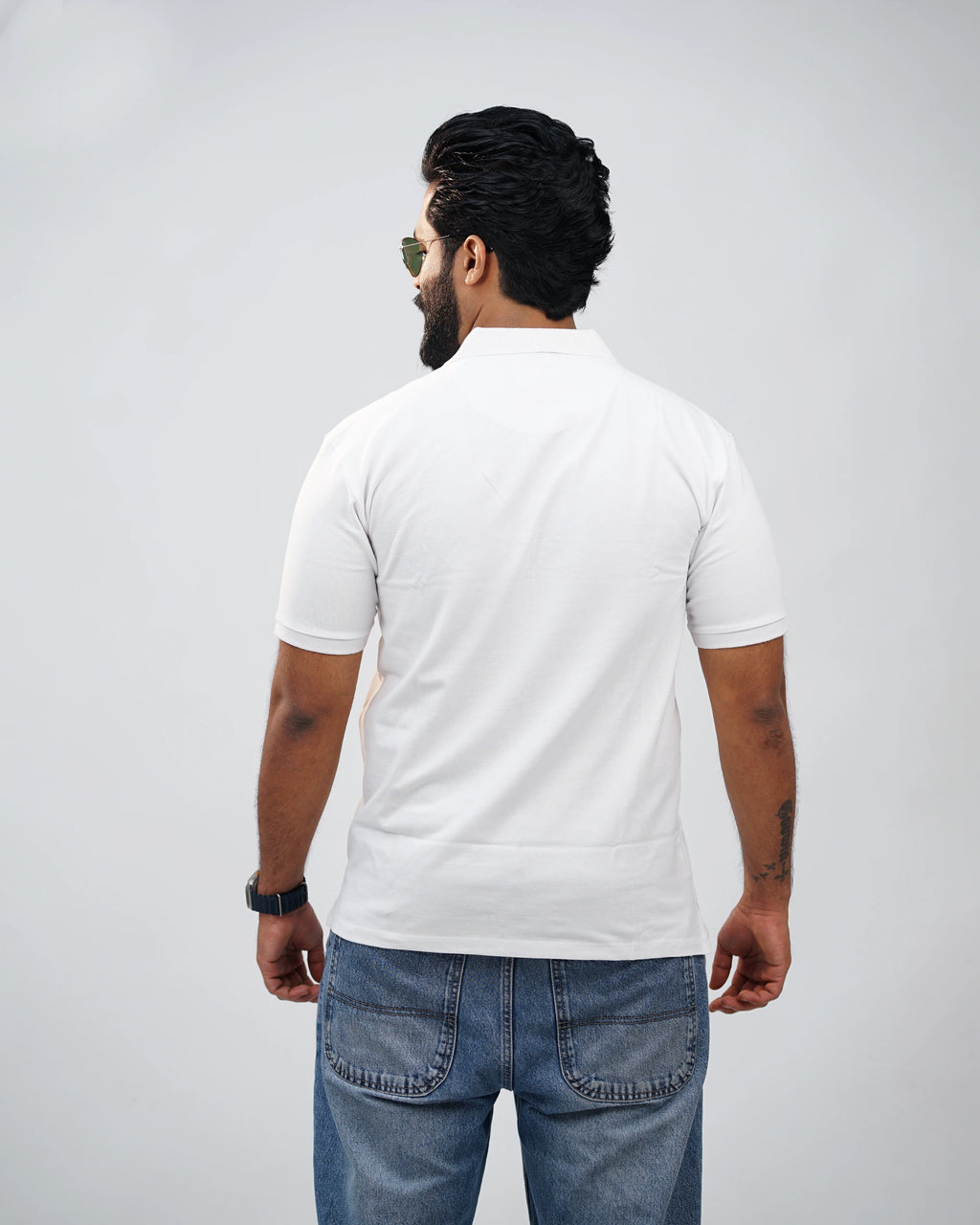 Back view of essential white polo tee highlighting clean finish & fit
