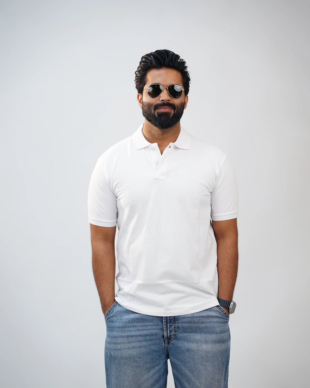 Man wearing essential white polo tee styled with chinos—clean, modern look