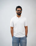 Man wearing essential white polo tee styled with chinos—clean, modern look
