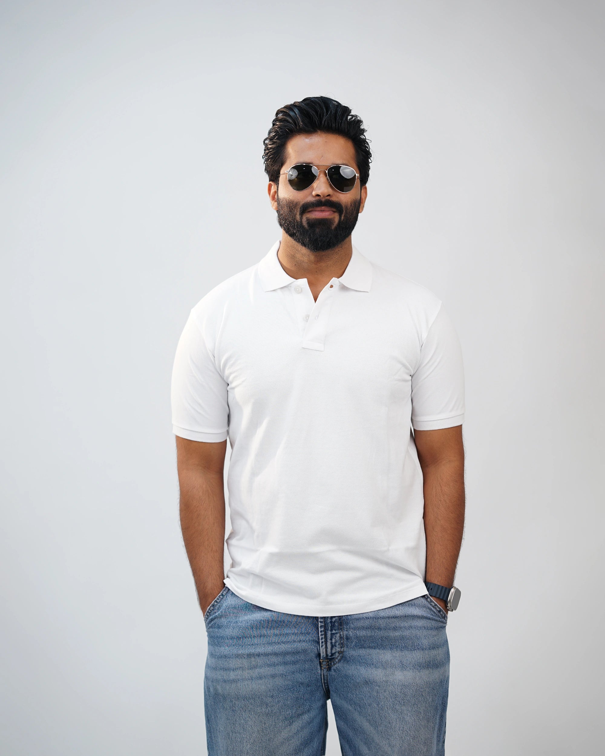 Man wearing essential white polo tee styled with chinos—clean, modern look