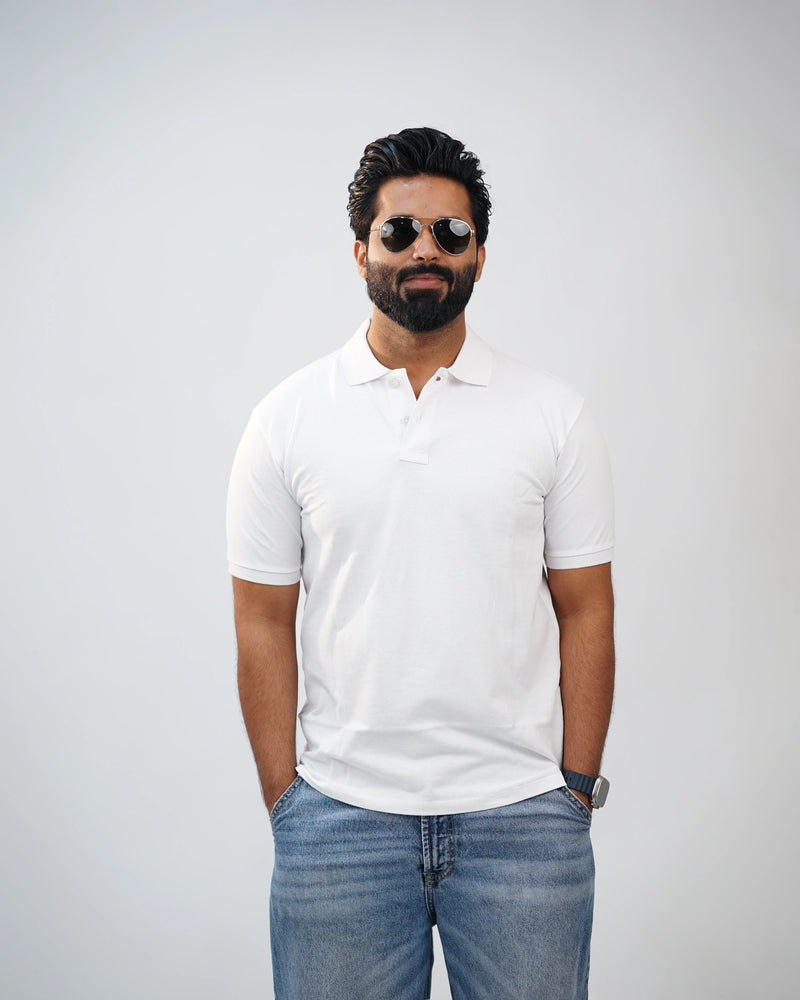 Man wearing essential white polo tee styled with chinos—clean, modern look