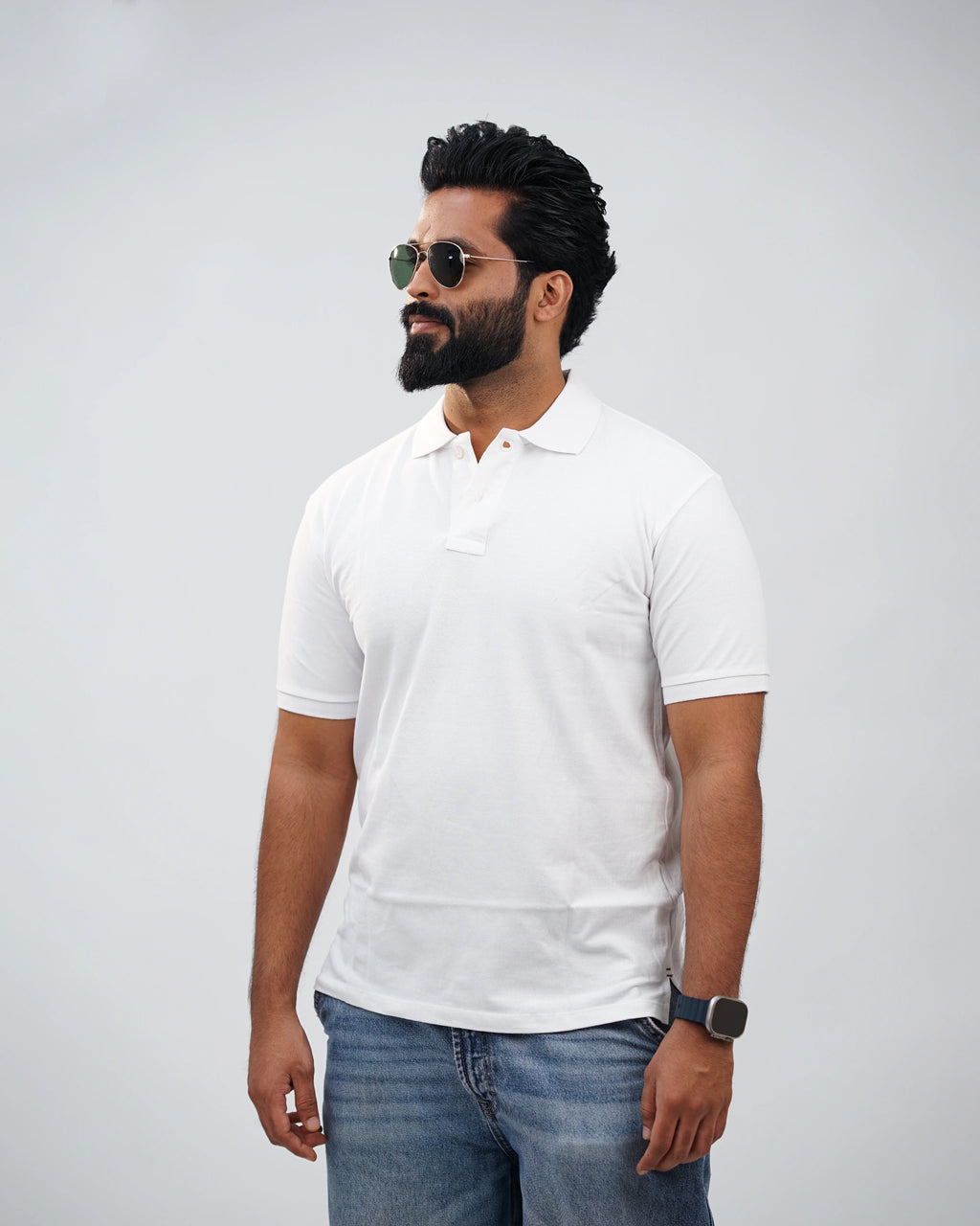 Man in essential white polo tee styled casually outdoors—everyday comfort