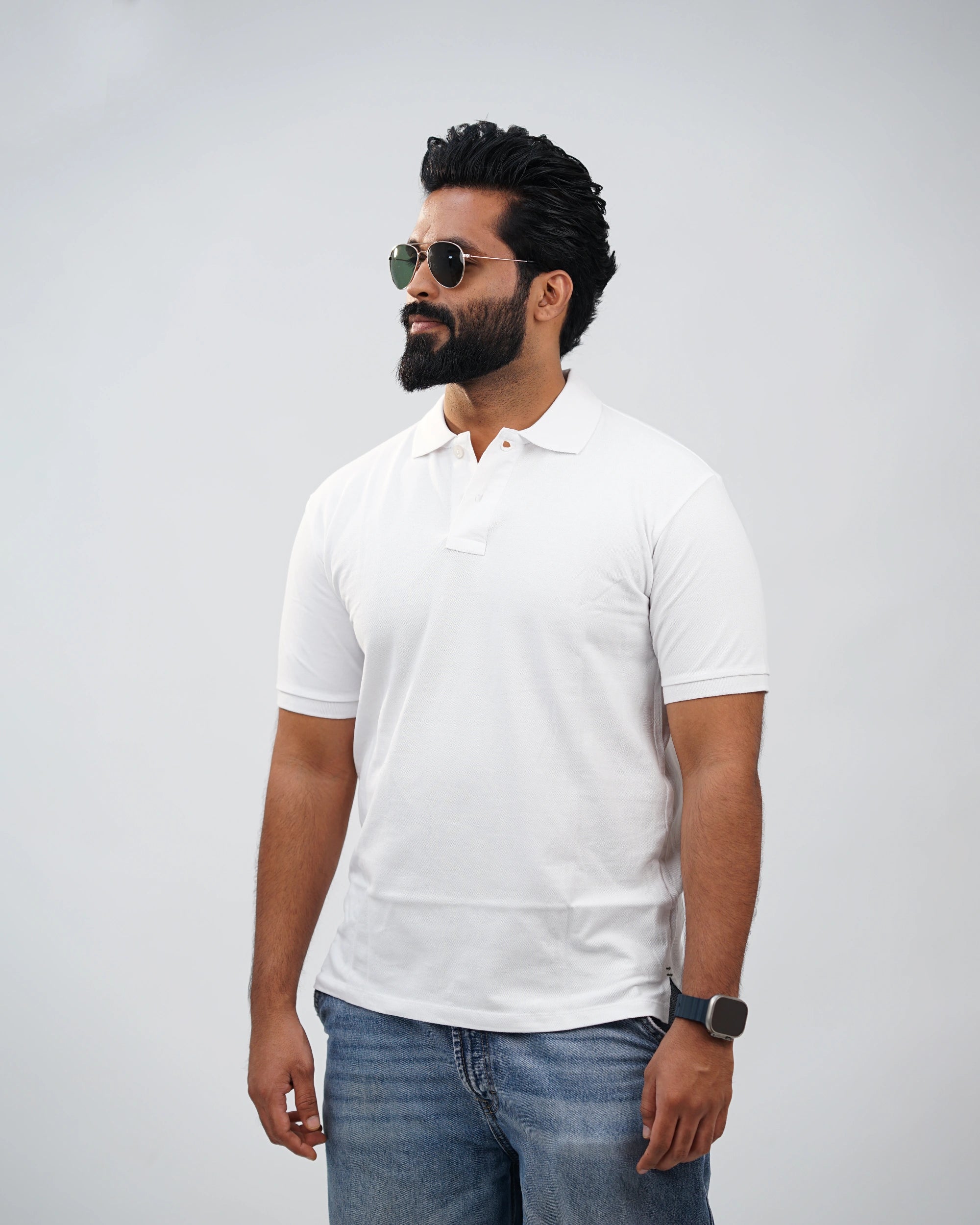 Man in essential white polo tee styled casually outdoors—everyday comfort