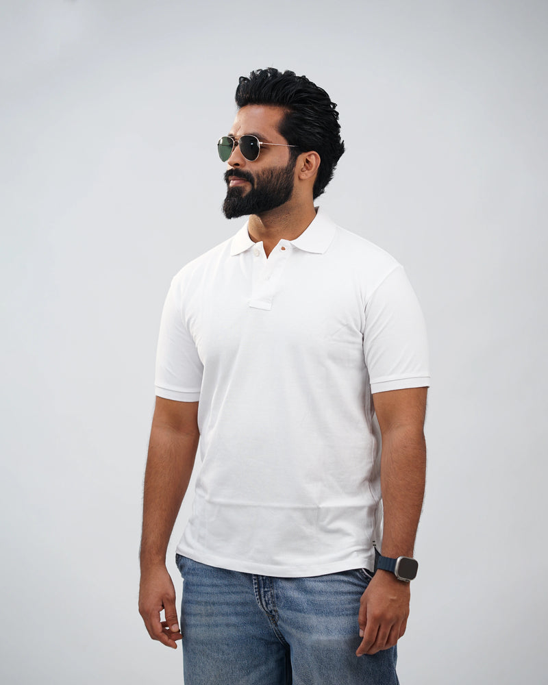 Man in essential white polo tee styled casually outdoors—everyday comfort