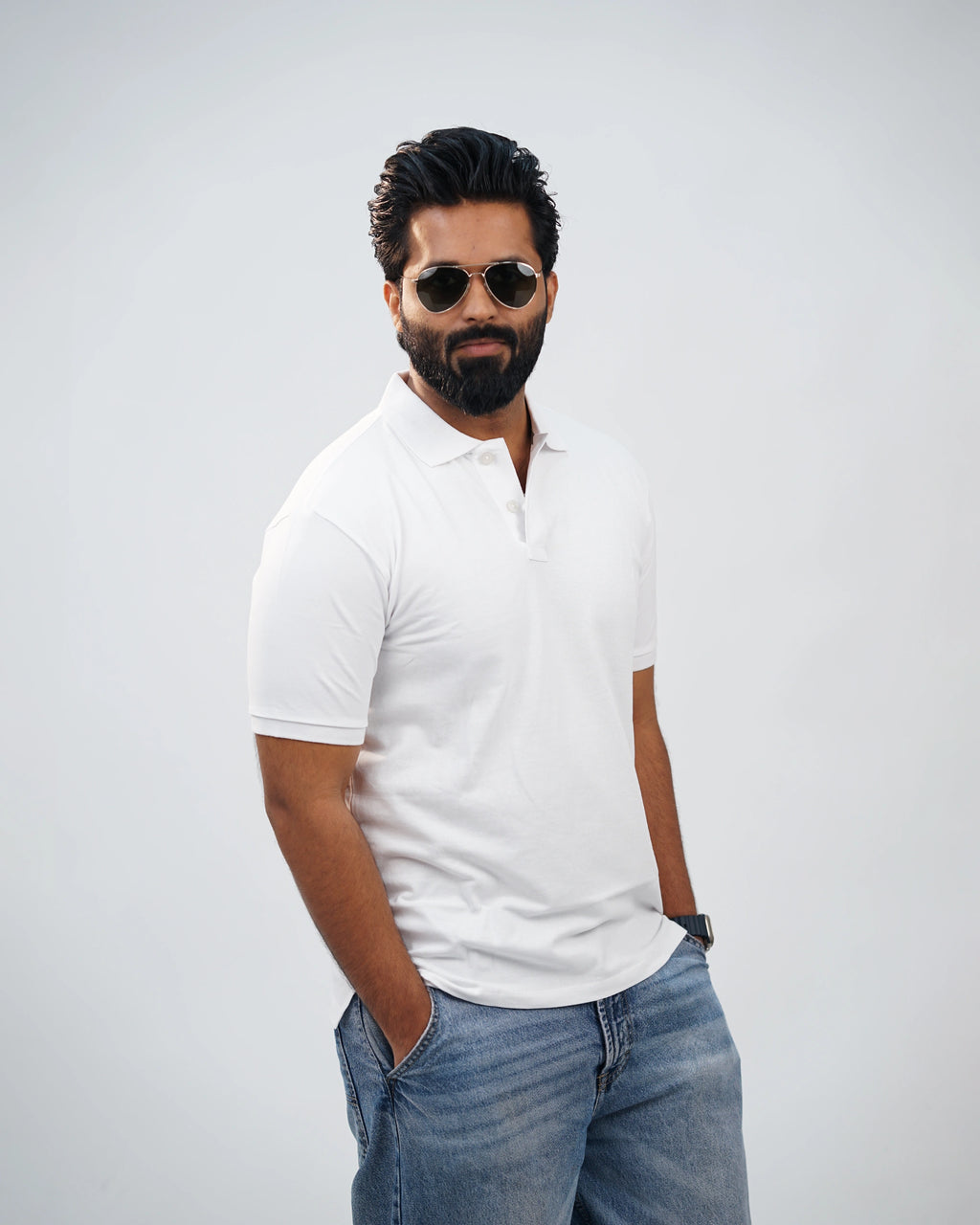 Side-angle view of white polo tee showing relaxed fit and smooth cotton