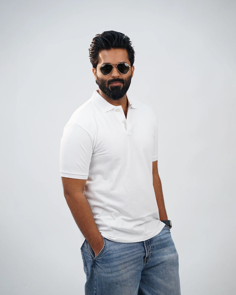 Side-angle view of white polo tee showing relaxed fit and smooth cotton