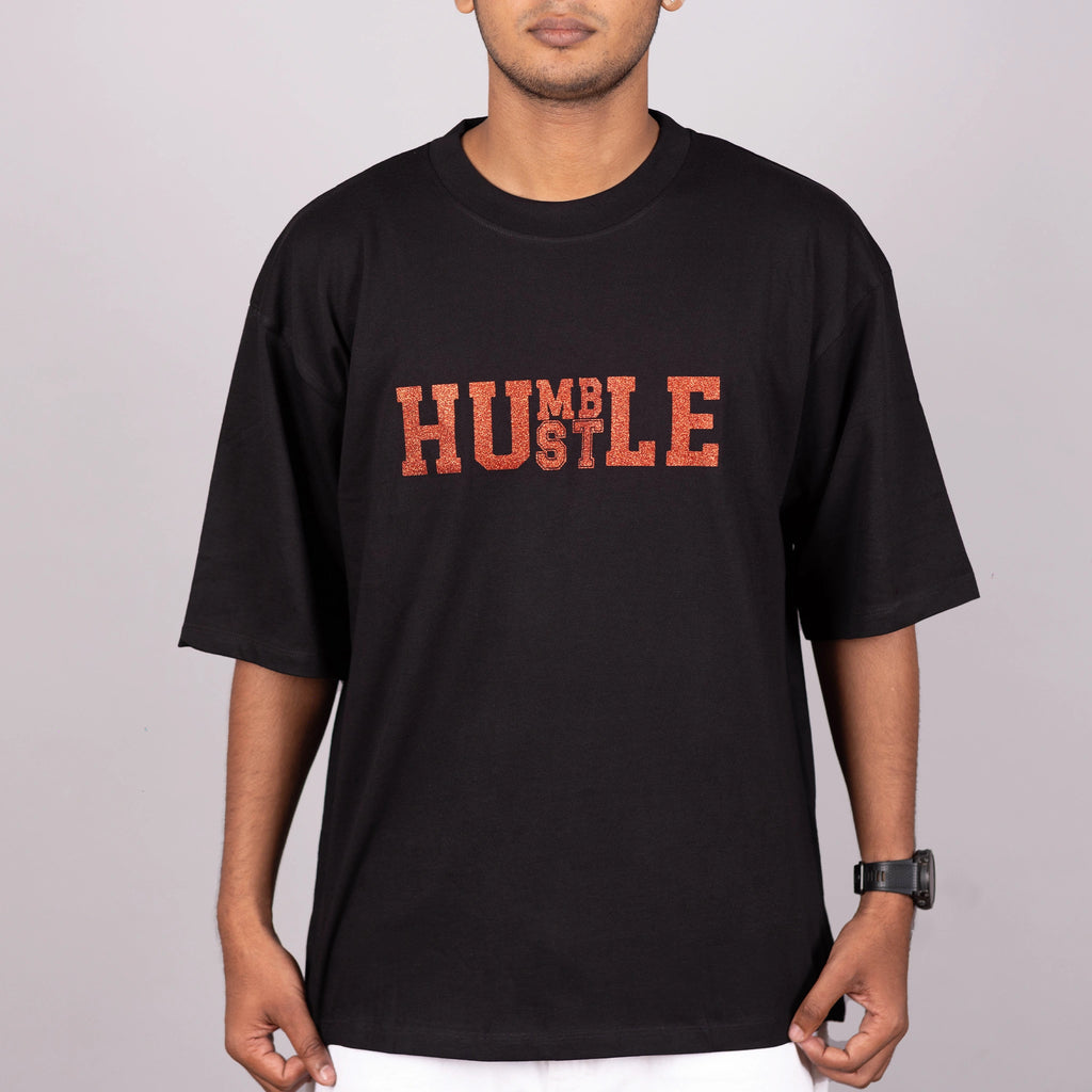 Close-up of “Humble Hustle” glitter print on soft fabric