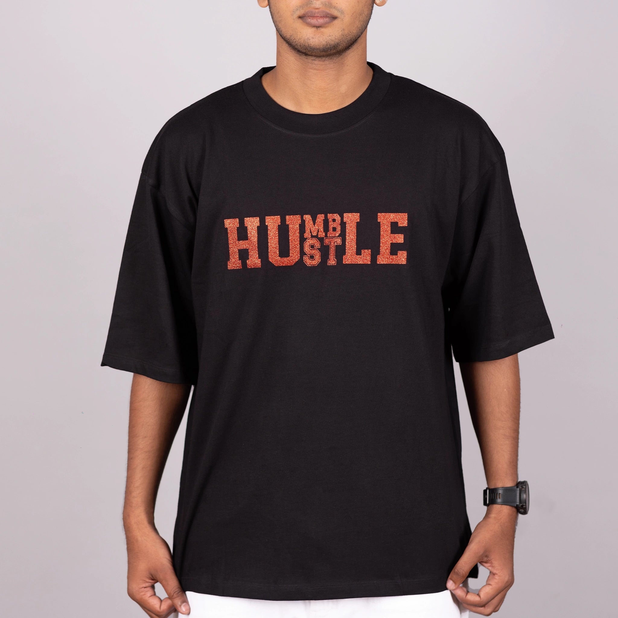Close-up of “Humble Hustle” glitter print on soft fabric