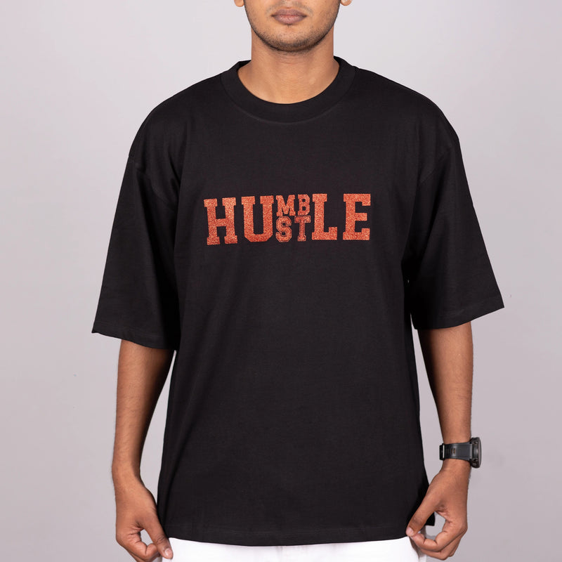 Close-up of “Humble Hustle” glitter print on soft fabric