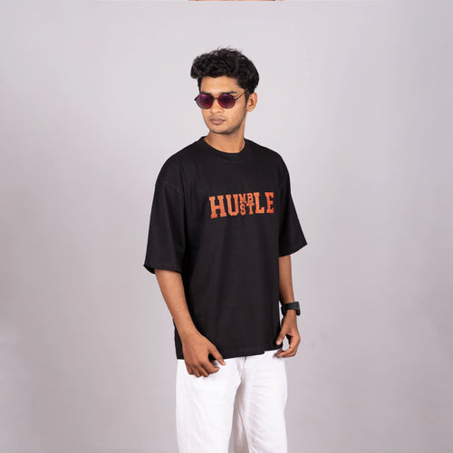 Oversized 'Humble Hustle' tee on man in India, relaxed urban style