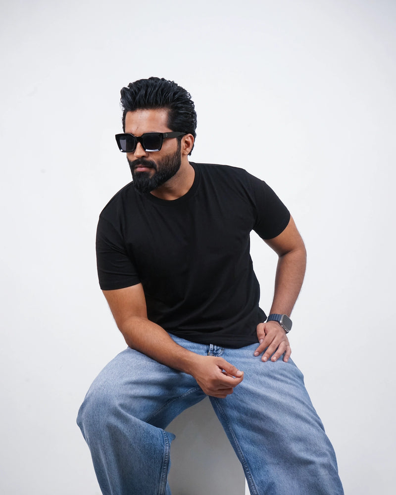 Relaxed view of jet black round-neck tee for men, smooth silhouette and soft fabric