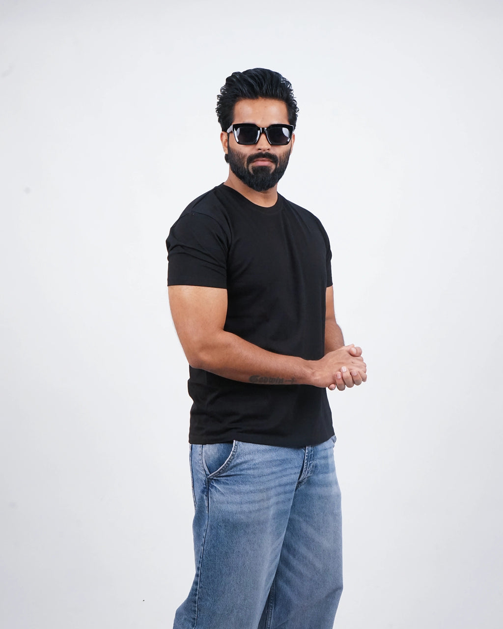 Man wearing a jet black round-neck tee for men in India — front view, minimalist fit