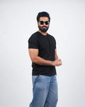 Man wearing a jet black round-neck tee for men in India — front view, minimalist fit