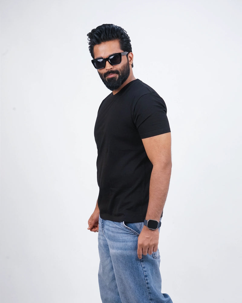 Side profile of jet black tee showcasing a clean fit and premium cotton texture