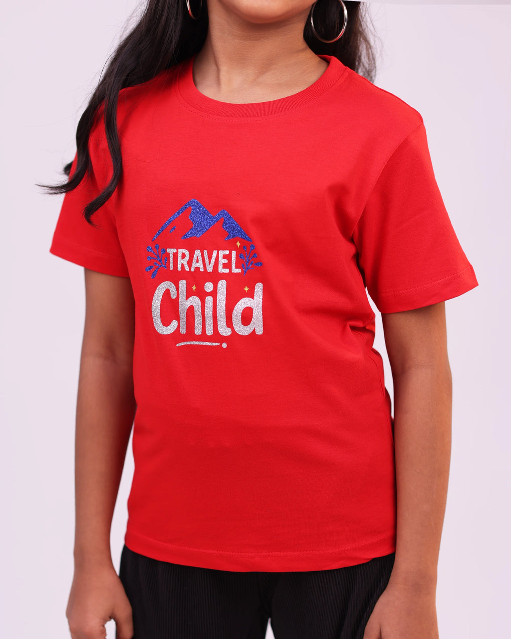 Kid wearing “Travel Child” tee outdoors—adventure-ready casual look
