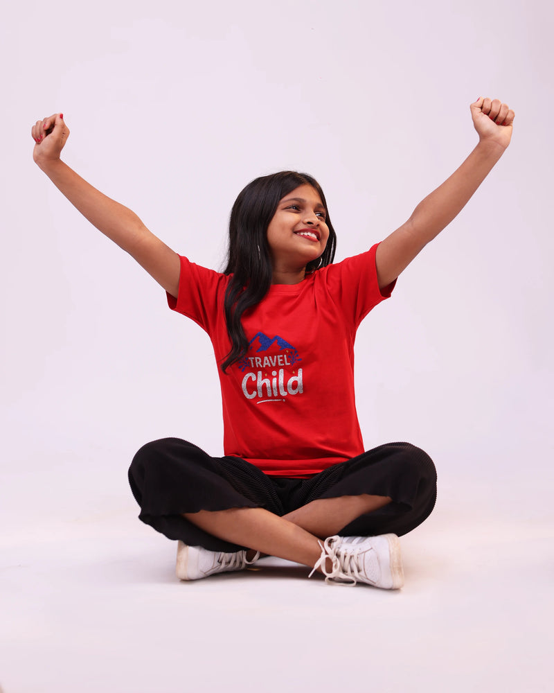 Side pose of “Travel Child” kids tee—relaxed fit, travel-inspired design