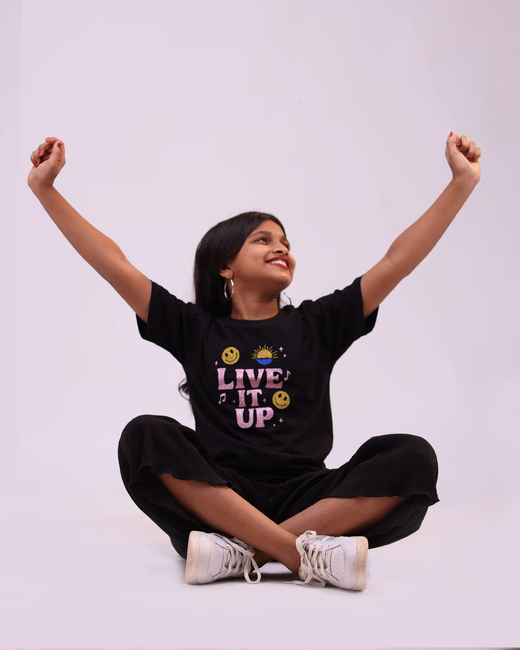 Close-up of “Live It Up” print on black kids tee — vibrant design and soft cotton