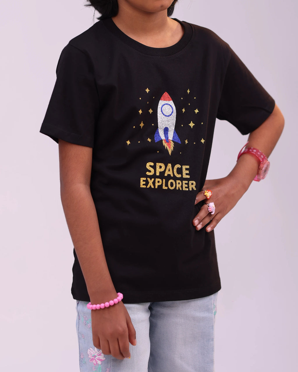 Close-up of the “Space Explorer” print—glimmering design on cozy kids tee fabric