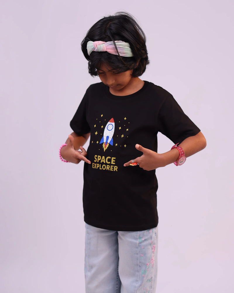 Girl wearing “Space Explorer” tee, playful and curious—moments of fun captured